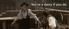 Doc Holliday from Tombstone raising his hands up, holding guns and saying "you're a daisy if you do"